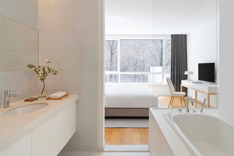 Minimalist hotel furniture collection, featuring sleek designs for guest room spaces. Perfect for modern, understated luxury hospitality interiors.